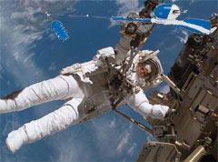Astronaut Chrissie Buglebong attaches prototype rod and reel device during a dry run simulation